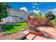 The backyard features lush green grass, mature landscaping, and a concrete patio at 10057 Cedaridge Way, Highlands Ranch, CO 80129