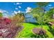 The backyard features lush green grass, mature landscaping, and a view of the house at 10057 Cedaridge Way, Highlands Ranch, CO 80129