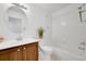 Bright bathroom with tub and shower combo, wood vanity and decorative mirror at 10057 Cedaridge Way, Highlands Ranch, CO 80129