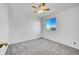 Bright bedroom with neutral carpet features a window with lovely views and a ceiling fan at 10057 Cedaridge Way, Highlands Ranch, CO 80129