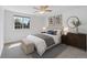 Bright bedroom with a ceiling fan, decor, large window, and neutral color palette at 10057 Cedaridge Way, Highlands Ranch, CO 80129