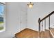 Second floor landing with hardwood floors, white walls, and a window with a view of trees and the neighboring house at 10057 Cedaridge Way, Highlands Ranch, CO 80129