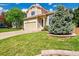 Charming two-story home with a well-manicured lawn, mature blue spruce, and a two car garage at 10057 Cedaridge Way, Highlands Ranch, CO 80129