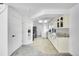 Long kitchen with white cabinets, stone countertops, recessed lighting, and black appliances at 10057 Cedaridge Way, Highlands Ranch, CO 80129