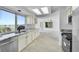 Bright kitchen with granite countertops, stainless steel appliances, and a large window overlooking the yard at 10057 Cedaridge Way, Highlands Ranch, CO 80129