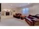 Cozy living room with leather furniture, recessed lighting, and built-in shelving at 10057 Cedaridge Way, Highlands Ranch, CO 80129
