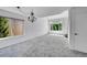 Bright living area with neutral carpeting, a chandelier, two windows, and a closet at 10057 Cedaridge Way, Highlands Ranch, CO 80129