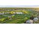 Aerial view of green golf course, community and ponds at 8767 Chase Dr # 195, Arvada, CO 80003