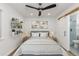 Serene bedroom with a comfortable bed, minimalist decor, and a sliding barn door to the bathroom at 8767 Chase Dr # 195, Arvada, CO 80003