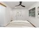 Bright bedroom featuring a comfortable bed, neutral decor, a ceiling fan, and ample closet space at 8767 Chase Dr # 195, Arvada, CO 80003