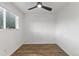 Bright bedroom with wood-look floors and a dark ceiling fan at 8767 Chase Dr # 195, Arvada, CO 80003