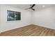 Bedroom with wood floors and large window offering natural light at 8767 Chase Dr # 195, Arvada, CO 80003