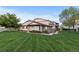 Townhouse complex featuring manicured lawn and mature trees at 8767 Chase Dr # 195, Arvada, CO 80003