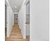 Hallway with wood-look floors and access to a linen closet for storage at 8767 Chase Dr # 195, Arvada, CO 80003