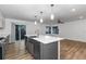Bright kitchen with a large island, stainless steel appliances, and wood-look flooring at 8767 Chase Dr # 195, Arvada, CO 80003