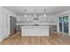 Bright kitchen featuring gray cabinets, white island, and stainless steel appliances at 8767 Chase Dr # 195, Arvada, CO 80003