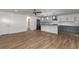 Bright living area featuring open layout, wood floors, and modern kitchen with island at 8767 Chase Dr # 195, Arvada, CO 80003