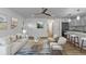 Cozy living space featuring a modern kitchen with island seating, a comfortable sofa, and stylish decor at 8767 Chase Dr # 195, Arvada, CO 80003
