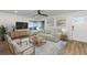 Bright living room with a cozy sofa, stylish decor, a ceiling fan, and a large window offering natural light at 8767 Chase Dr # 195, Arvada, CO 80003