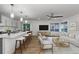 Open-concept living space featuring a kitchen island with bar seating, a comfortable sofa, and ample natural light at 8767 Chase Dr # 195, Arvada, CO 80003