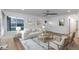 Inviting living room featuring a comfortable sofa, elegant decor, a ceiling fan, and a large window at 8767 Chase Dr # 195, Arvada, CO 80003