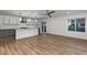 Open concept living area flows into a modern kitchen with stainless appliances, and wood floors at 8767 Chase Dr # 195, Arvada, CO 80003