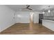 Spacious living area with wood floors, white plank accent walls, and modern fixtures at 8767 Chase Dr # 195, Arvada, CO 80003