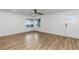 Light filled living room with wood-look floors, large windows, and a ceiling fan at 8767 Chase Dr # 195, Arvada, CO 80003