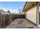 Outdoor patio with weathered concrete surface and wooden fence at 8767 Chase Dr # 195, Arvada, CO 80003