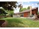 Beautiful backyard featuring a large lawn, multiple patios and mature landscaping at 10572 E Orchard Pl, Englewood, CO 80111