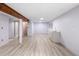 Finished basement with light wood flooring, wet bar, open layout and structural wood beam at 10572 E Orchard Pl, Englewood, CO 80111