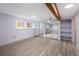 Finished basement featuring wood-look floors, mirrored closet doors, and natural light at 10572 E Orchard Pl, Englewood, CO 80111
