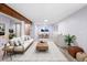 Digitally staged basement with light wood flooring, wet bar, open layout and structural wood beam at 10572 E Orchard Pl, Englewood, CO 80111