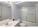 Bathroom features a shower and bathtub combo with a sliding glass door and a vanity with a mirror at 10572 E Orchard Pl, Englewood, CO 80111