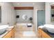 Luxurious bathroom featuring a soaking tub, double vanities, and modern fixtures at 10572 E Orchard Pl, Englewood, CO 80111