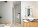 This bathroom features a glass enclosed shower and a vessel sink vanity with granite countertop at 10572 E Orchard Pl, Englewood, CO 80111