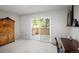 Bright bedroom featuring a sliding glass door to a private patio and stylish vintage furnishings at 10572 E Orchard Pl, Englewood, CO 80111