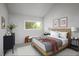 Bright bedroom featuring a window with green outdoor views and contemporary furnishings at 10572 E Orchard Pl, Englewood, CO 80111