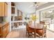 Bright dining area features vaulted ceilings, light-wood floors, and adjoins the living room at 10572 E Orchard Pl, Englewood, CO 80111