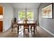 Dining room with large windows providing a pleasant view and a chandelier at 10572 E Orchard Pl, Englewood, CO 80111