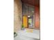 Welcoming entryway with a brightly colored door, brickwork and transom window at 10572 E Orchard Pl, Englewood, CO 80111
