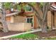Beautiful brick home featuring a walkway, mature trees, and nice landscaping at 10572 E Orchard Pl, Englewood, CO 80111