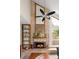 Tall brick fireplace with wood mantel, flanked by shelving, and a large window at 10572 E Orchard Pl, Englewood, CO 80111