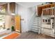 Bright foyer featuring a staircase, wood floors, modern lighting, and views into the kitchen and living areas at 10572 E Orchard Pl, Englewood, CO 80111