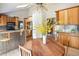 Bright kitchen and dining area with light-wood cabinets, stainless backsplash, and bar-top dining at 10572 E Orchard Pl, Englewood, CO 80111