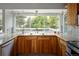 Kitchen featuring wood cabinets, granite countertops, stainless steel appliances and a large window at 10572 E Orchard Pl, Englewood, CO 80111