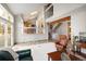 Open-concept living area with high ceilings, skylights, staircase, and seamless access to the deck and patio at 10572 E Orchard Pl, Englewood, CO 80111