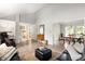 Hardwood floors extend through an open living space into the dining room and stairs at 10572 E Orchard Pl, Englewood, CO 80111