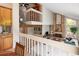Split level home featuring living room with brick fireplace, hardwood floors, and modern kitchen at 10572 E Orchard Pl, Englewood, CO 80111