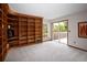 Large living room featuring built-in shelving, a sliding glass door to the patio and ample natural light at 10572 E Orchard Pl, Englewood, CO 80111